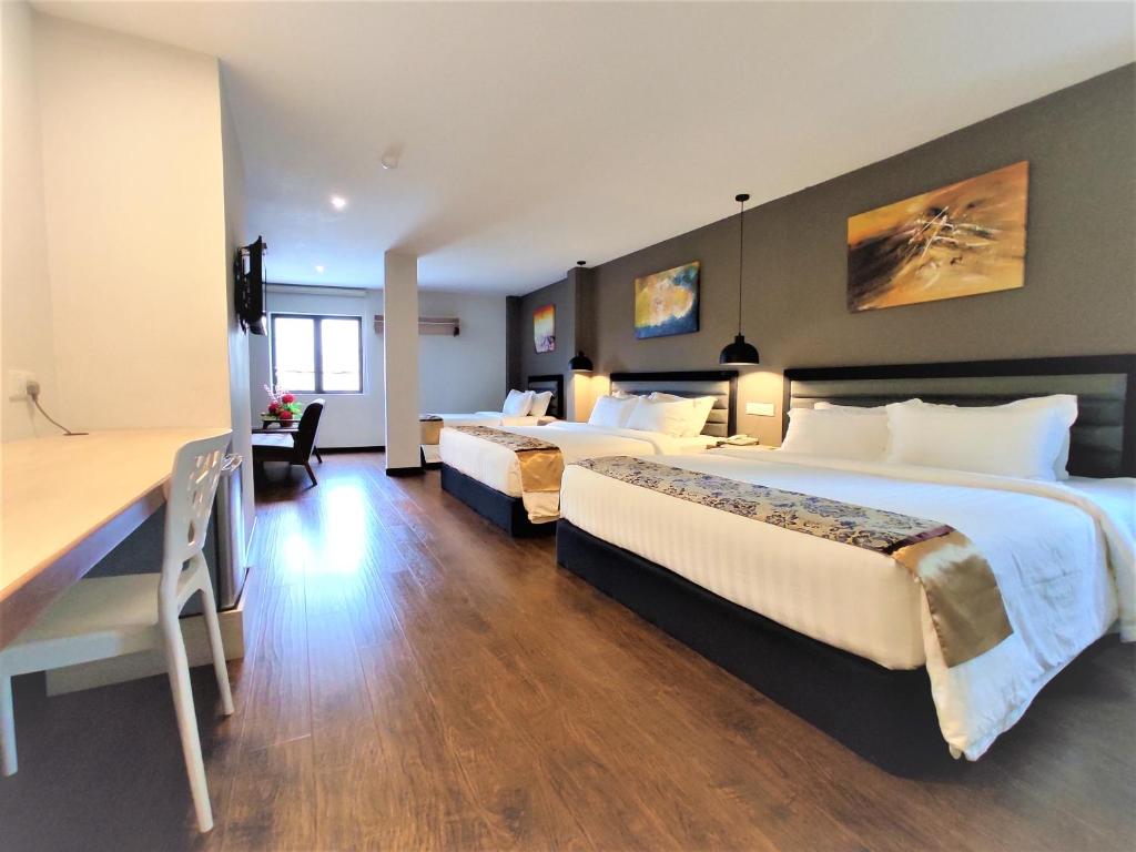 Postel nebo postele na pokoji v ubytování Apple Suites Hotel