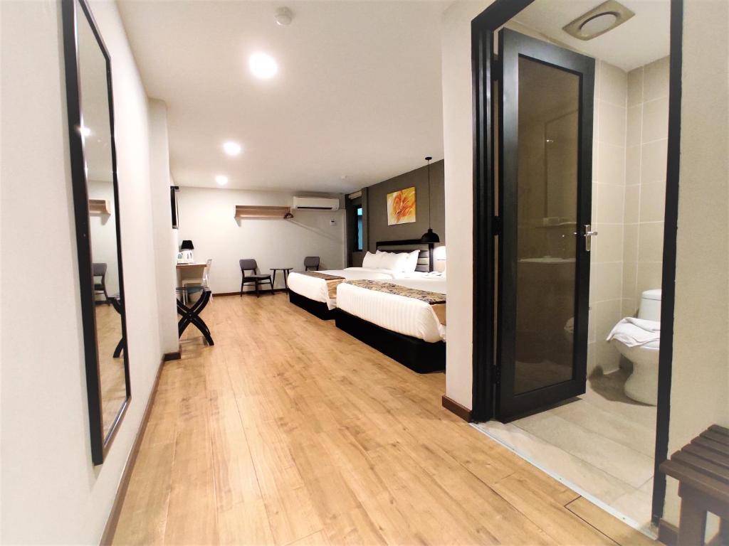 Postel nebo postele na pokoji v ubytování Apple Suites Hotel