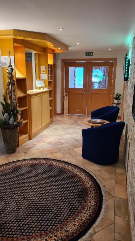 a lobby with a waiting area with chairs and a table at Chasa Monthani in Ischgl