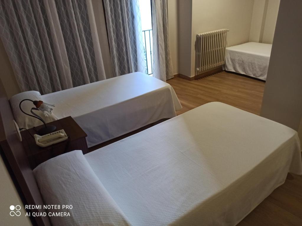Łóżko lub łóżka w pokoju w obiekcie Hosteria de Rafi