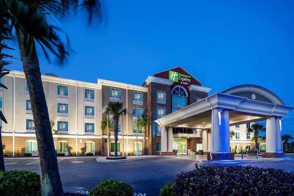 a hotel with a gas station in front of it at Holiday Inn Express & Suites Florence, an IHG Hotel in Florence