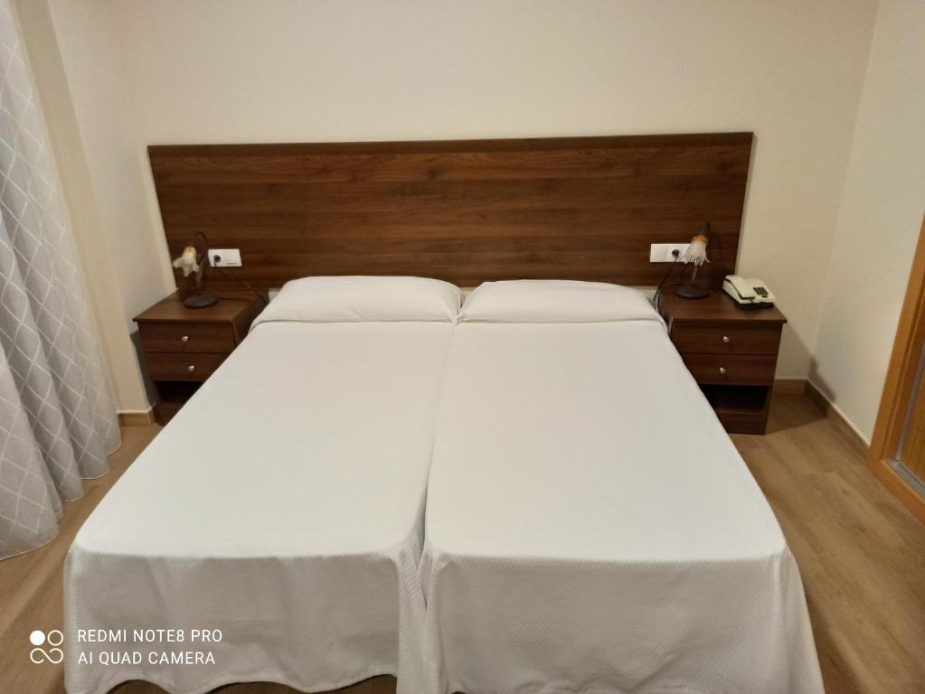 Łóżko lub łóżka w pokoju w obiekcie Hosteria de Rafi