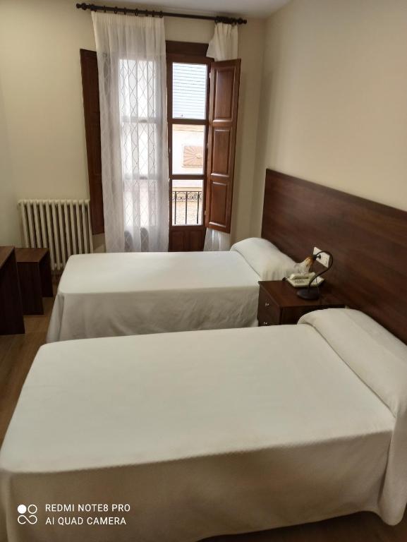 Łóżko lub łóżka w pokoju w obiekcie Hosteria de Rafi