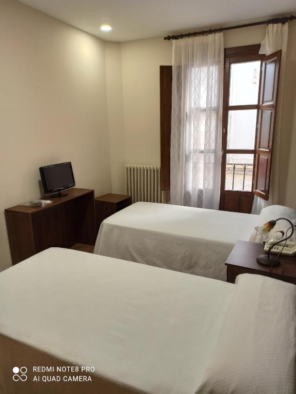 Łóżko lub łóżka w pokoju w obiekcie Hosteria de Rafi