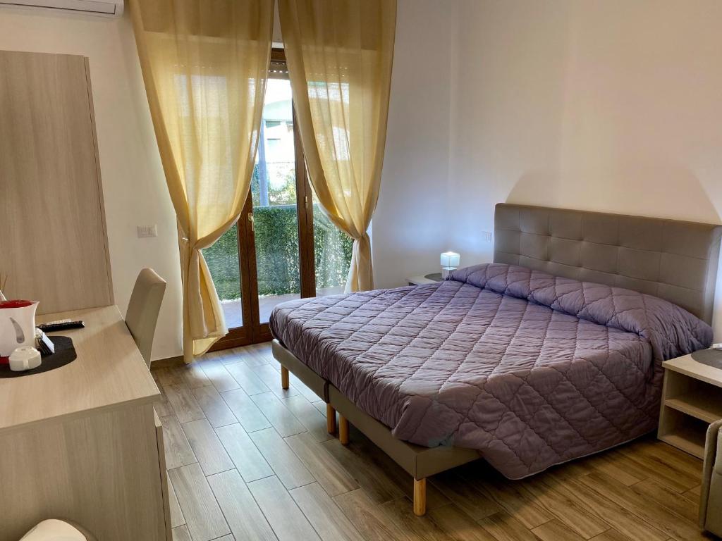 Postel nebo postele na pokoji v ubytování Caruso Rooms