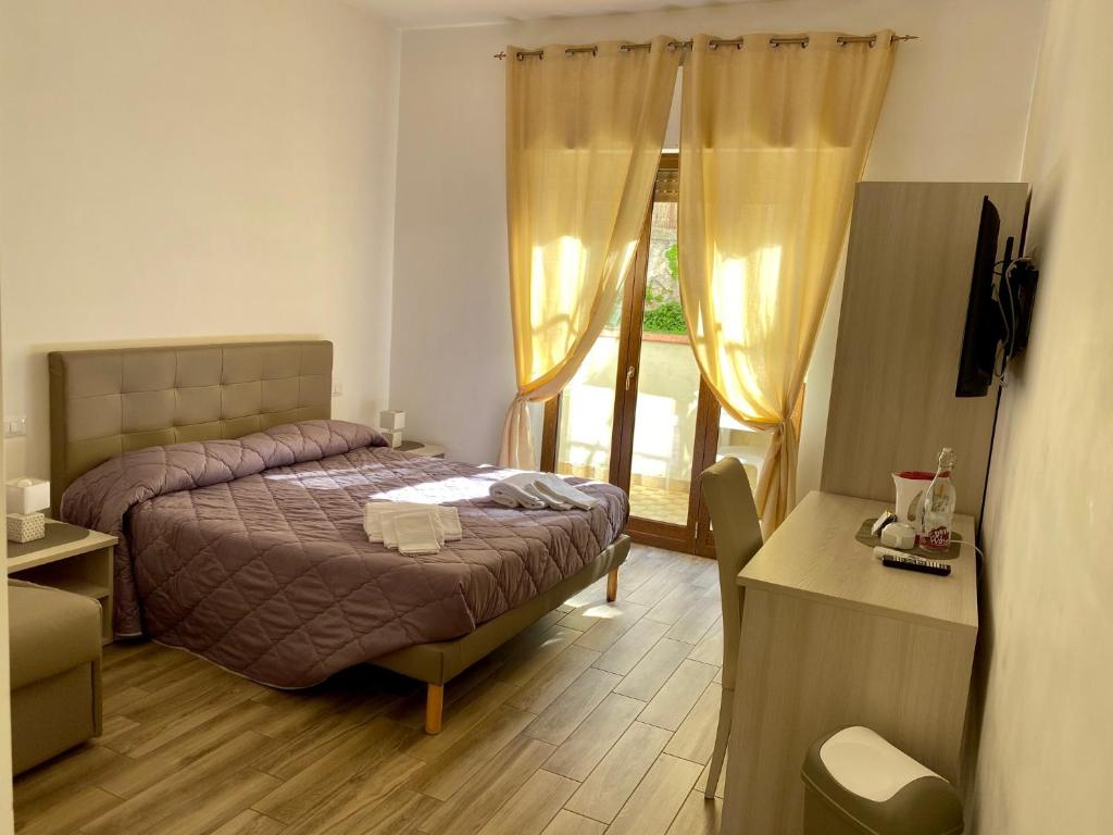 Postel nebo postele na pokoji v ubytování Caruso Rooms
