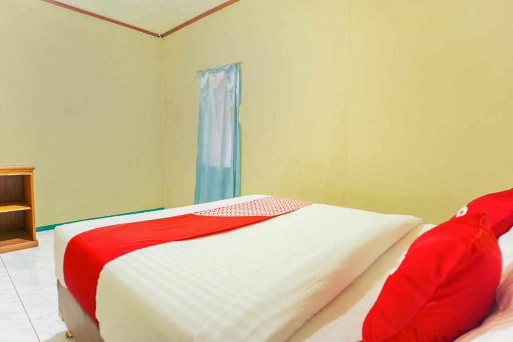 Postel nebo postele na pokoji v ubytování OYO 2180 Vina Vira Hotel