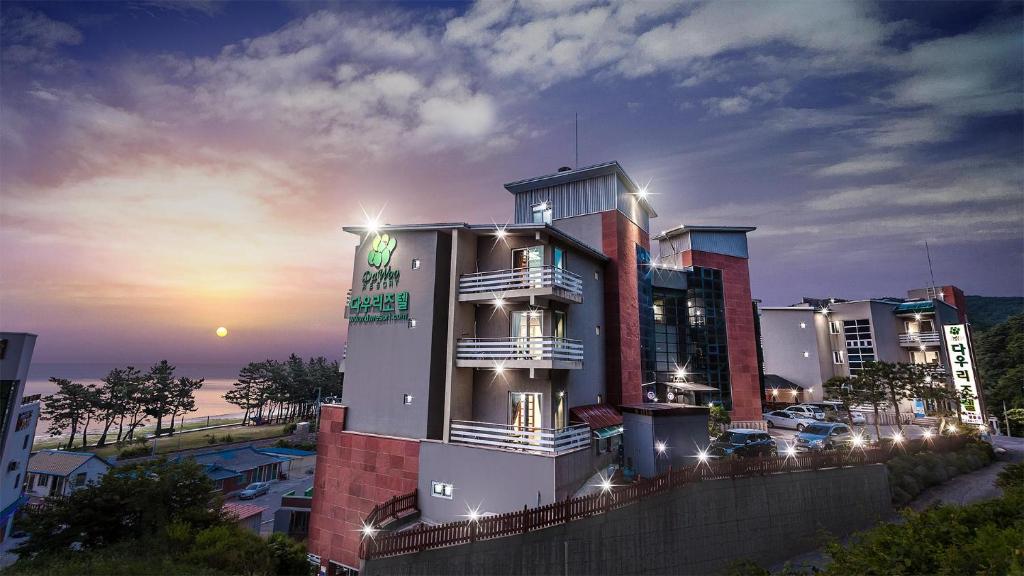 a building with lights on in a city at night at Dawoo Resortel in Gangneung