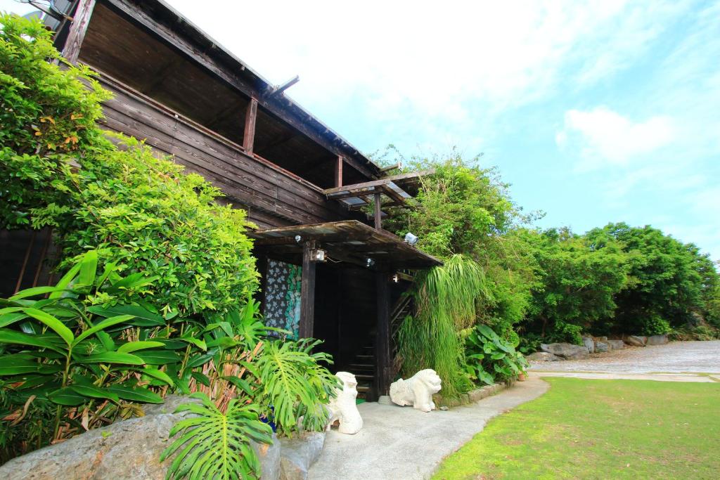 a building with two bears sitting outside of it at Kazenooka in Motobu