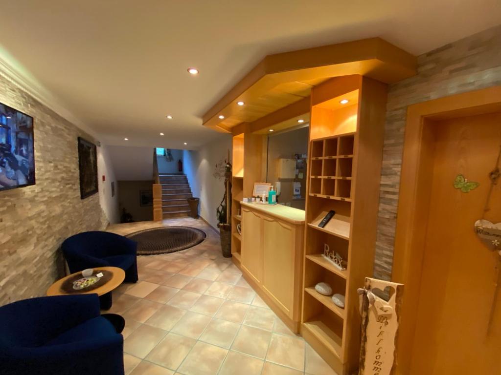 a living room with blue chairs and a sink at Chasa Monthani in Ischgl