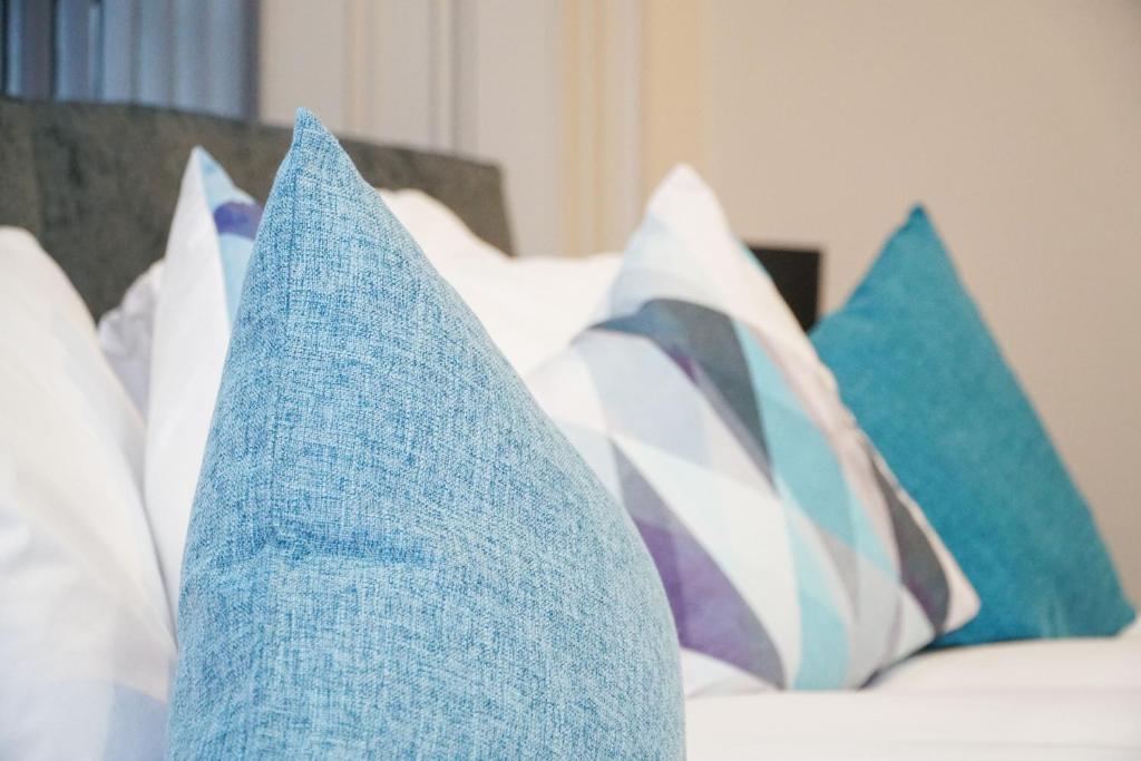 a group of pillows sitting on a bed at Castle View in Dudley