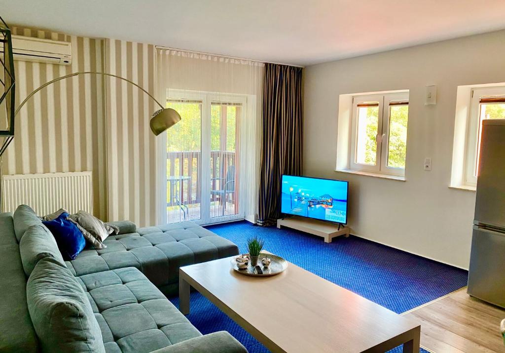 A seating area at Słupsk forest PREMIUM HOTEL APARTAMENT M6 - Kaszubska street 18 - Wifi Netflix Smart TV50 - two bedrooms two extra large double beds - up to 6 people full - pleasure quality stay