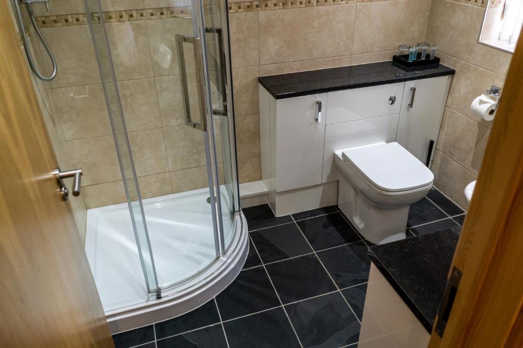 a bathroom with a shower and a toilet at The Windmill Inn in Watchet