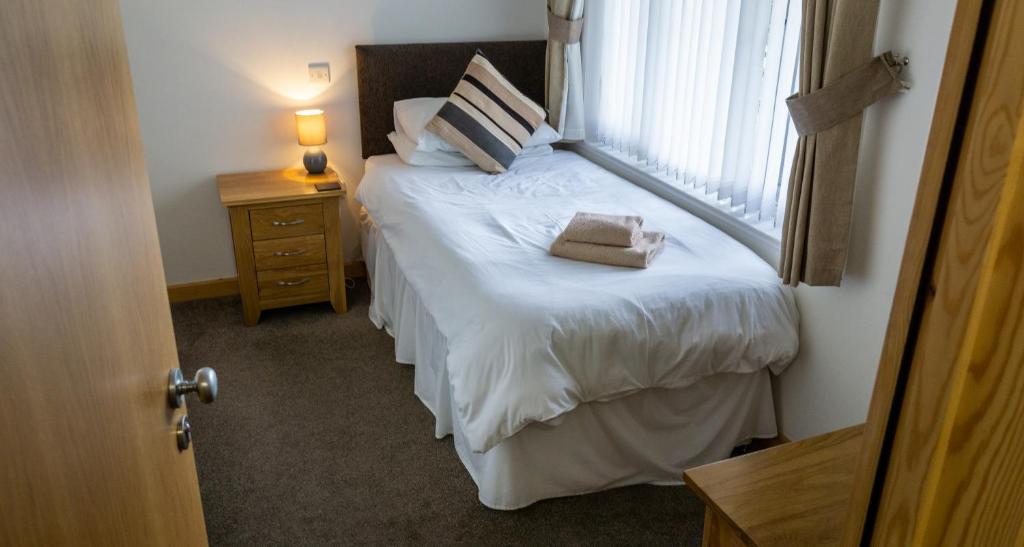 a bedroom with a bed with a large window at The Windmill Inn in Watchet