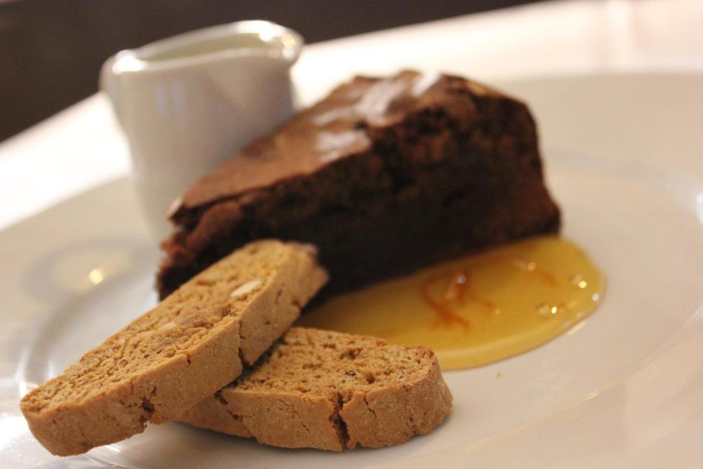 a plate with a chocolate cake and two pieces of bread at The Windmill Inn in Watchet