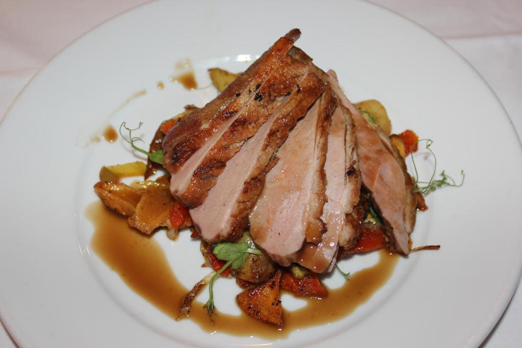 a plate of food with a piece of meat on top at The Windmill Inn in Watchet