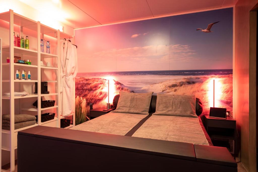 a bedroom with a wall mural of a beach at Hotel en privé-wellness De Nieuwe Doelen in Middelburg