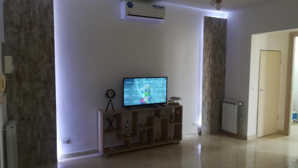 a living room with a flat screen tv on a table at Stella Marina - voglia di vacanza e di relax in Genova
