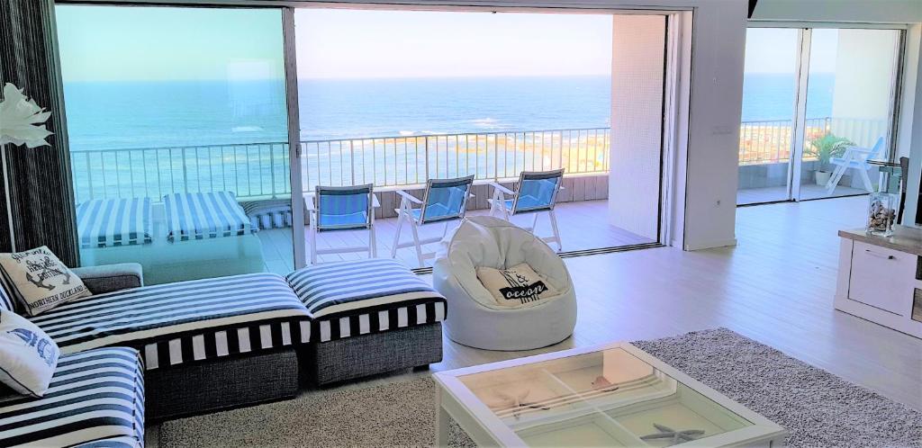 a living room with a view of the ocean at Avenida dos Banhos Apartment in Póvoa de Varzim