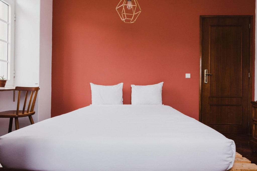 Postel nebo postele na pokoji v ubytování Jaca Hostel Porto da Cruz