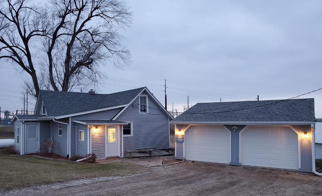 a house with a garage with lights on it at THE LOST GEM.... A Little Bit Country in Oskaloosa