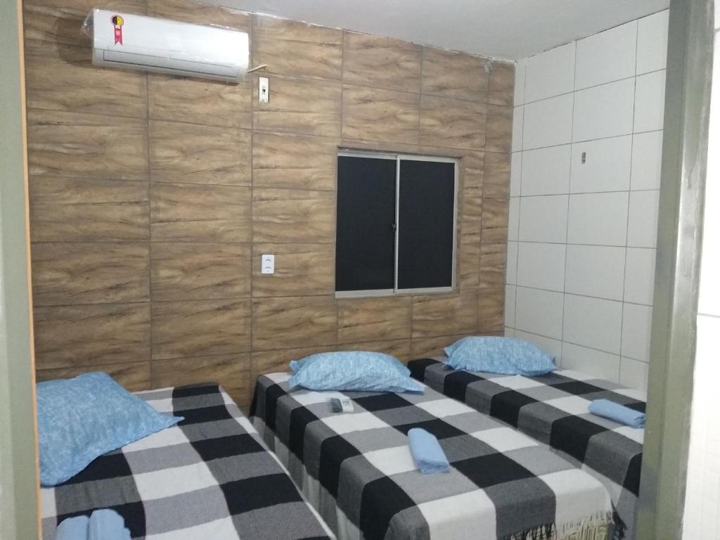 two twin beds in a room with a tv at HOTEL CIDADE EXPRESS 24H in Teresina