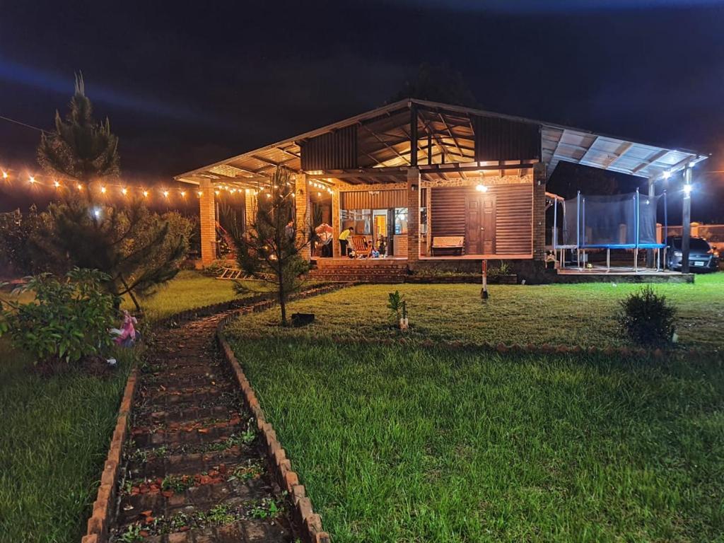 a house at night with lights in the background at Villa Isabella, La Sucursal del Cielo in Siguatepeque