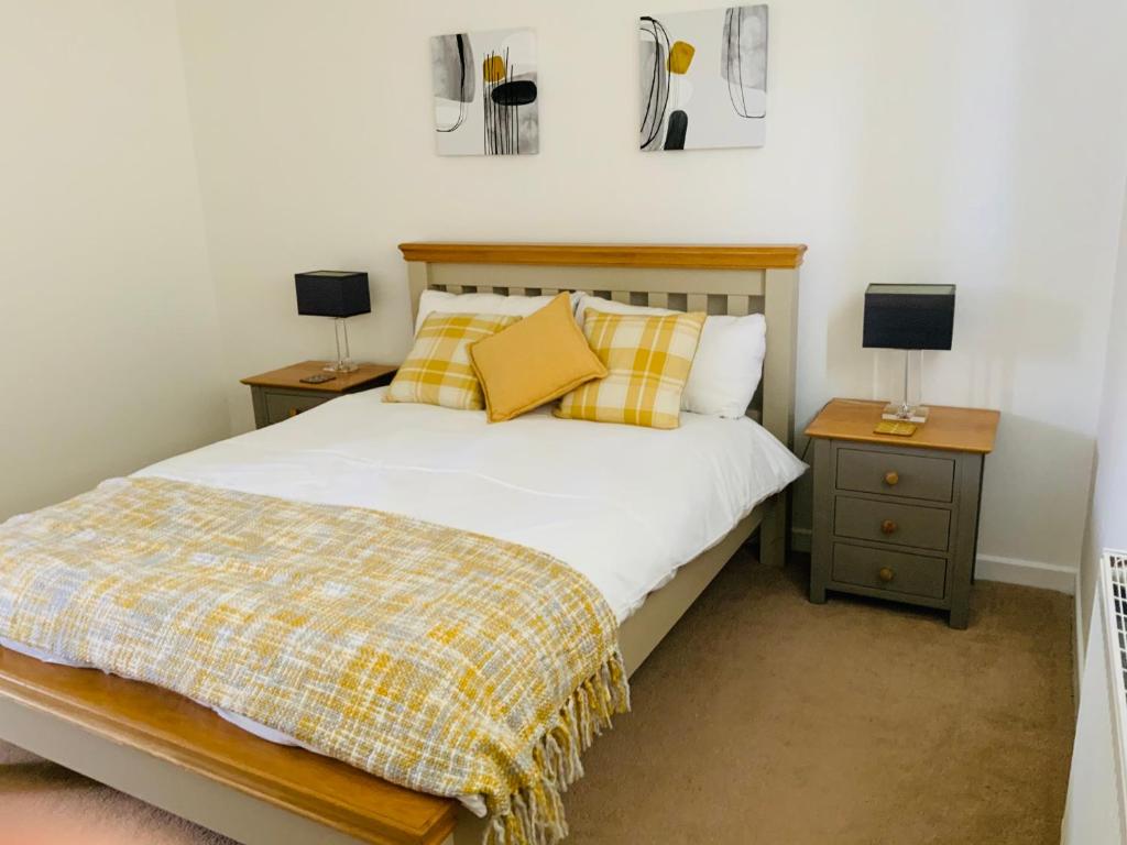a bedroom with a bed and two night stands at Furzy House in Pembrokeshire
