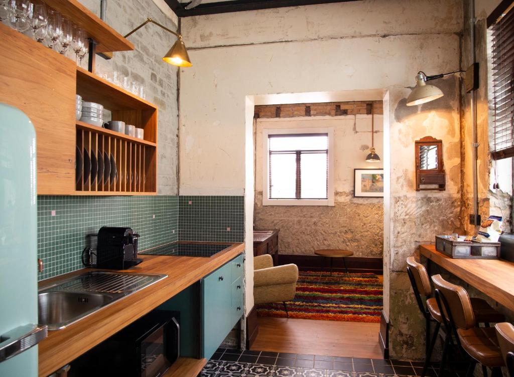 a kitchen with a sink and a counter top at The Convent Hotel in Auckland