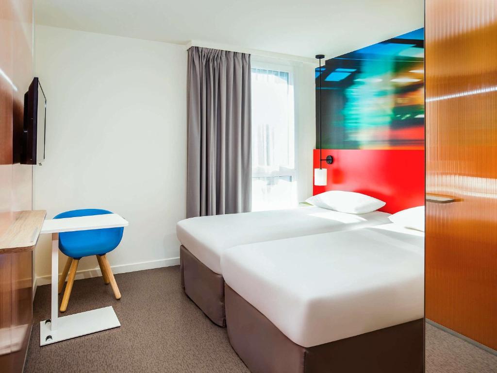 Postel nebo postele na pokoji v ubytování Ibis Styles Mulhouse Centre Gare