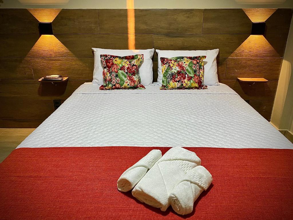 En eller flere senge i et værelse på Terra D` Ouro Apart Hotel