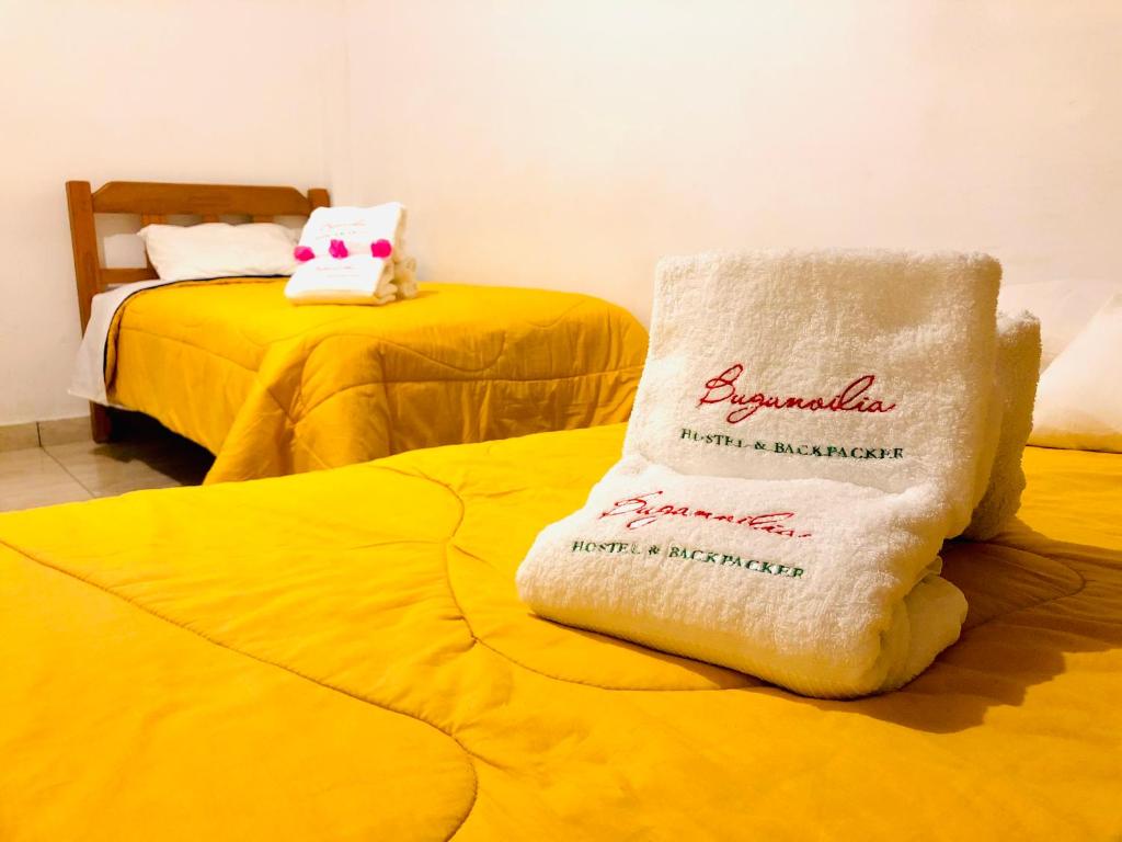 a white towel sitting on top of two beds at BUGANVILIA in Paracas