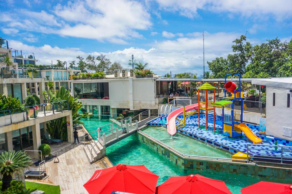 勒吉安的住宿－巴厘島水明漾富麗華海灘酒店，一个带水上滑梯的水上公园的游泳池