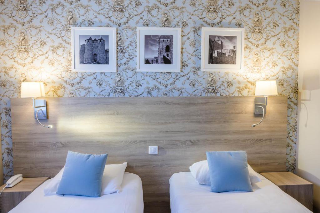 Postel nebo postele na pokoji v ubytování Hôtel l'Aragon