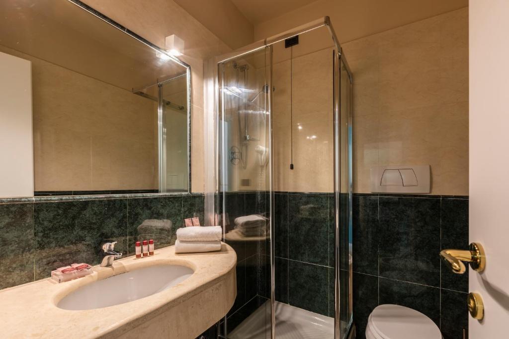 a bathroom with a sink and a shower at Hotel Coppede' in Rome