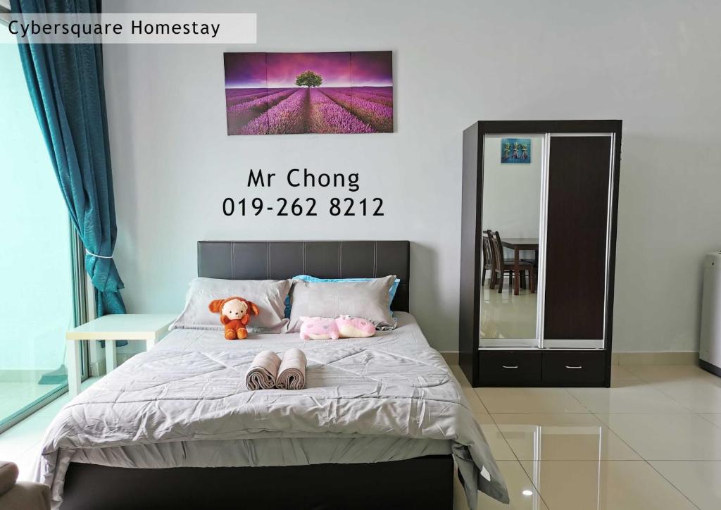 a bedroom with a bed with two slippers on it at Cybersqaure Studio Suites with Netfilx @10 min walking distance to McD in Cyberjaya