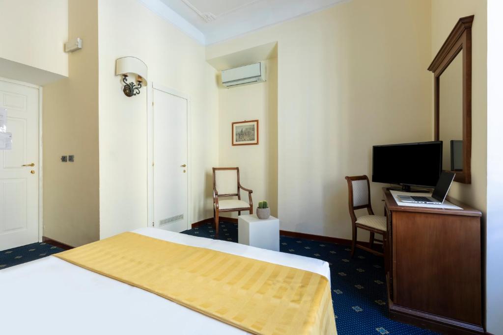 a hotel room with a bed and a desk and a computer at Hotel Coppede' in Rome