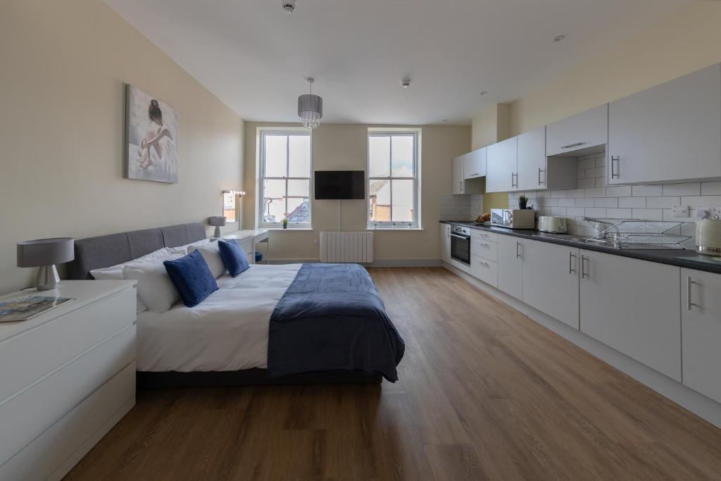 a large bedroom with a bed and a kitchen at Apartment 7, Isabella House, Aparthotel, By RentMyHouse in Hereford