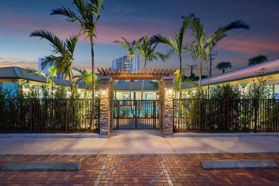 a gate to a house with palm trees at Bermuda Bungalows (Tropical Island Getaway) in West Palm Beach