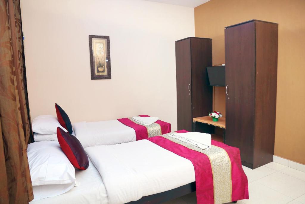 Postel nebo postele na pokoji v ubytování DAFFODILS SERVICED APARTMENT