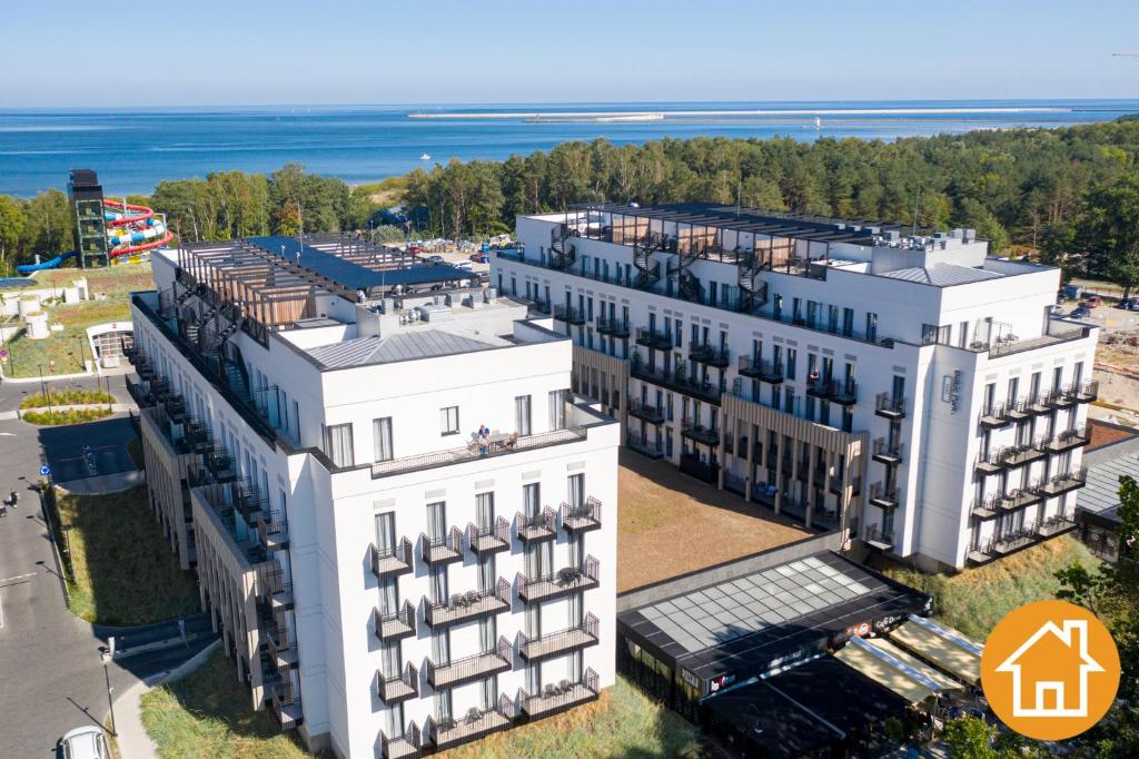 an aerial view of a building with the ocean in the background at Apartamenty Baltic Fort - visitopl in Świnoujście