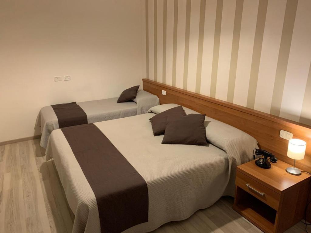 Voodi või voodid majutusasutuse Hotel Castel Miramonti toas
