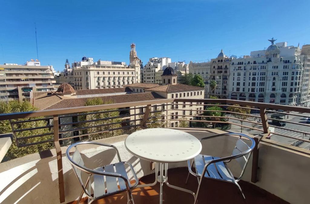 a balcony with a white table and two chairs at Sunny apartment with fantastic terrace views! in Valencia