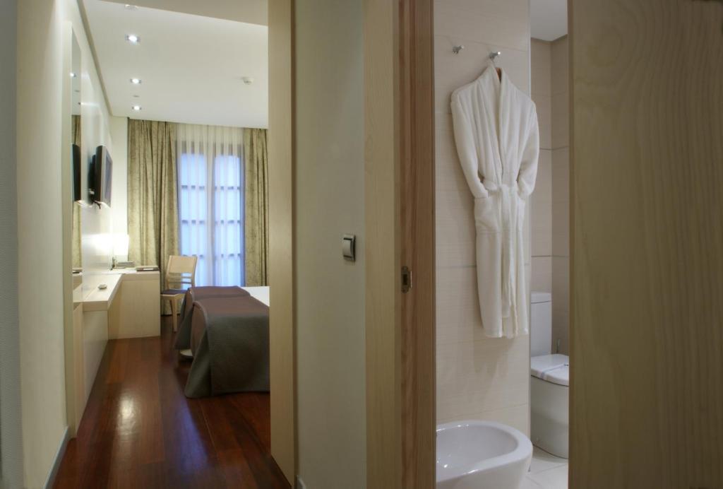 Postel nebo postele na pokoji v ubytování Hotel Mozart