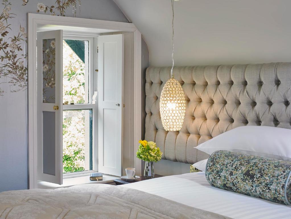 a bedroom with a large bed and a window at Killarney Randles Hotel in Killarney