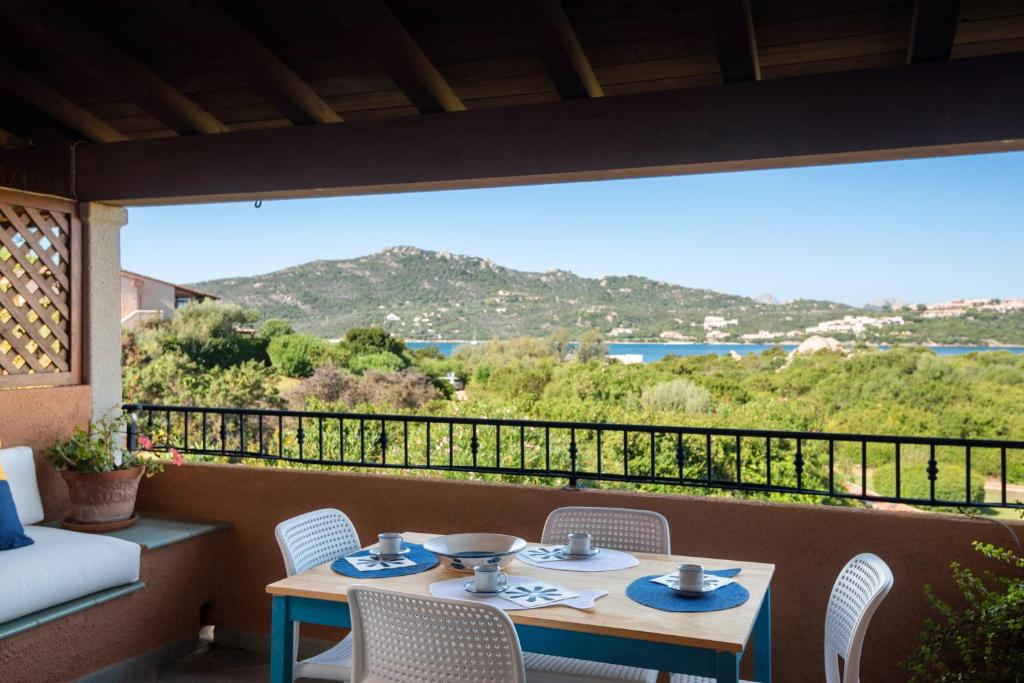 a room with a balcony with a table and chairs at Punta Marana in Santa Marinella