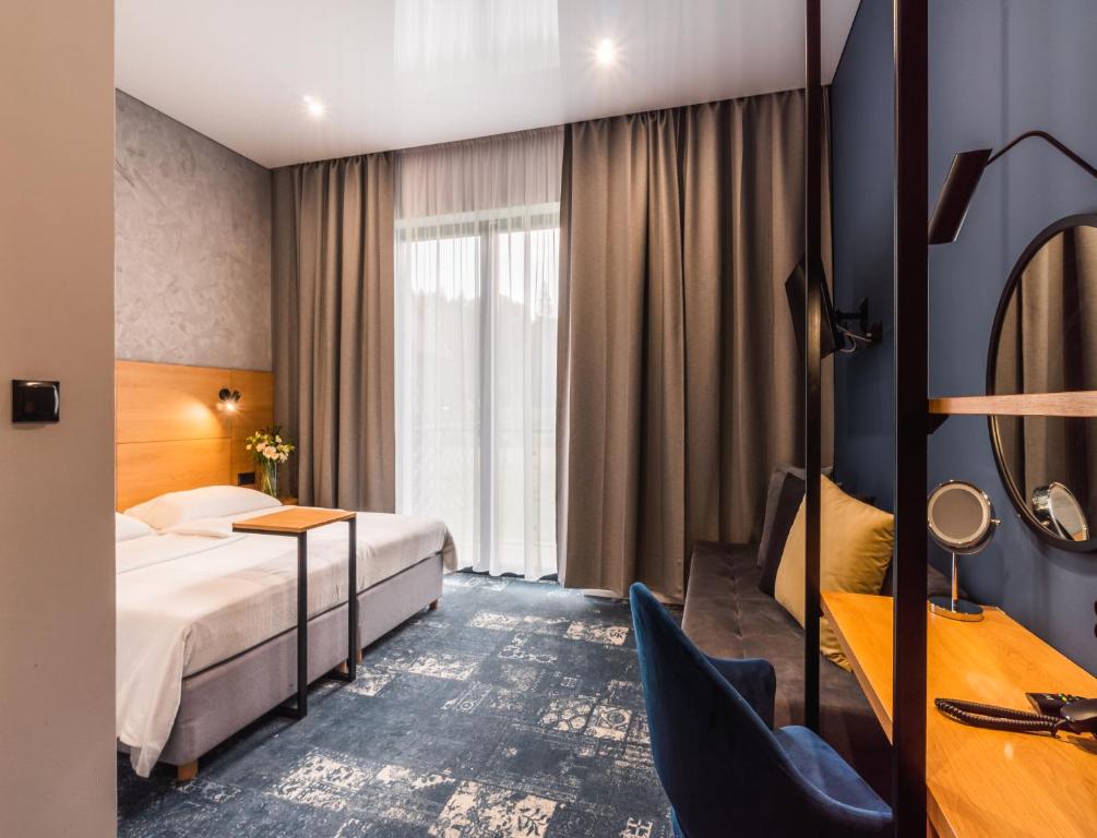 Postel nebo postele na pokoji v ubytování Caryńska Resort & SPA