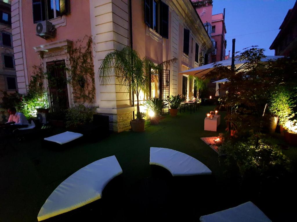 a courtyard of a building at night with lights at Hotel Coppede' in Rome