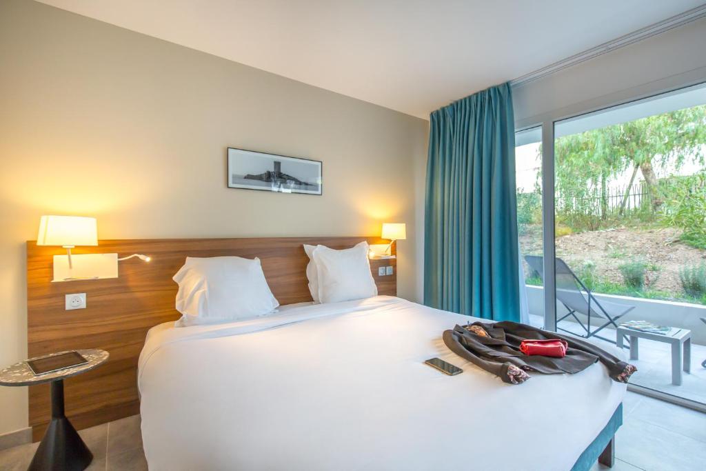 Postel nebo postele na pokoji v ubytování SOWELL HOTELS La Plage