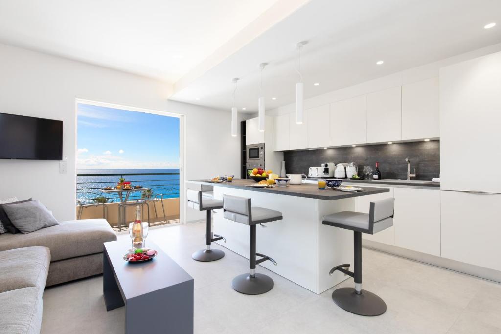 a kitchen and living room with a view of the ocean at Blue Dreams YourHostHelper in Cannes
